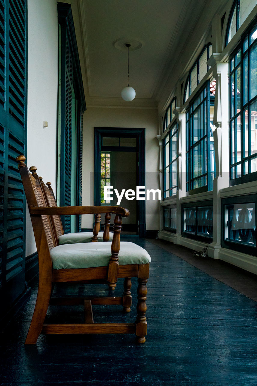 EMPTY CHAIRS AND TABLES IN ROOM