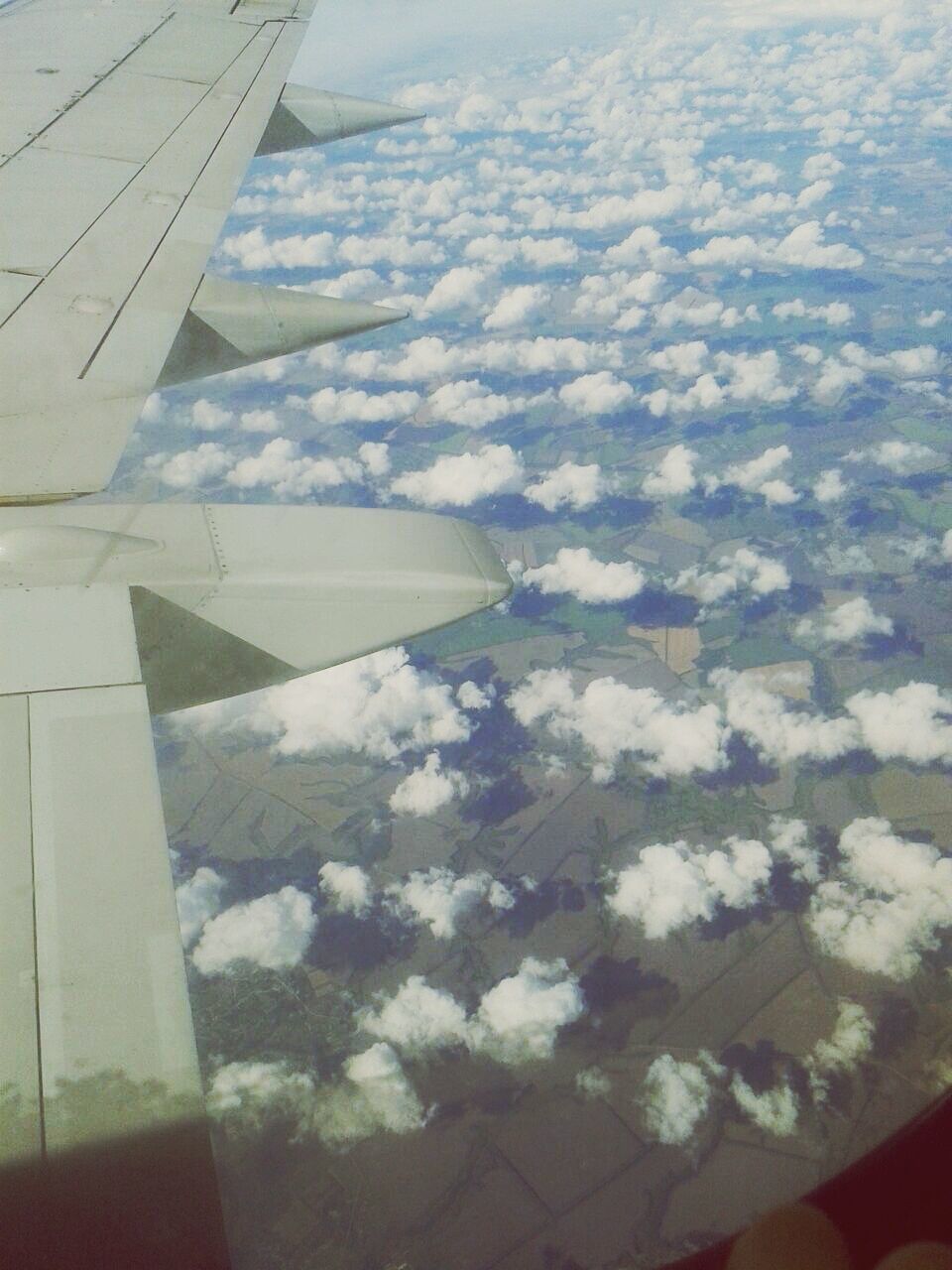 AERIAL VIEW OF AIRCRAFT WING OVER LANDSCAPE