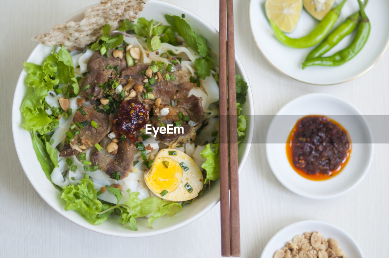 Vietnamese noodle - my quang, vietnamese traditional cuisine, noodles in bowl on the table 