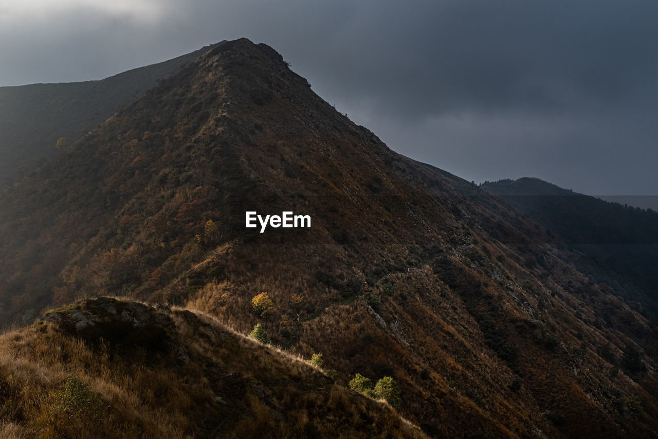 mountain, landscape, environment, cloud, nature, scenics - nature, sky, beauty in nature, land, ridge, volcano, travel destinations, summit, non-urban scene, no people, fog, highland, travel, geology, wilderness, volcanic landscape, outdoors, mountain range, overcast, mountain peak, tourism, activity, rock, plant, dramatic sky, tranquility