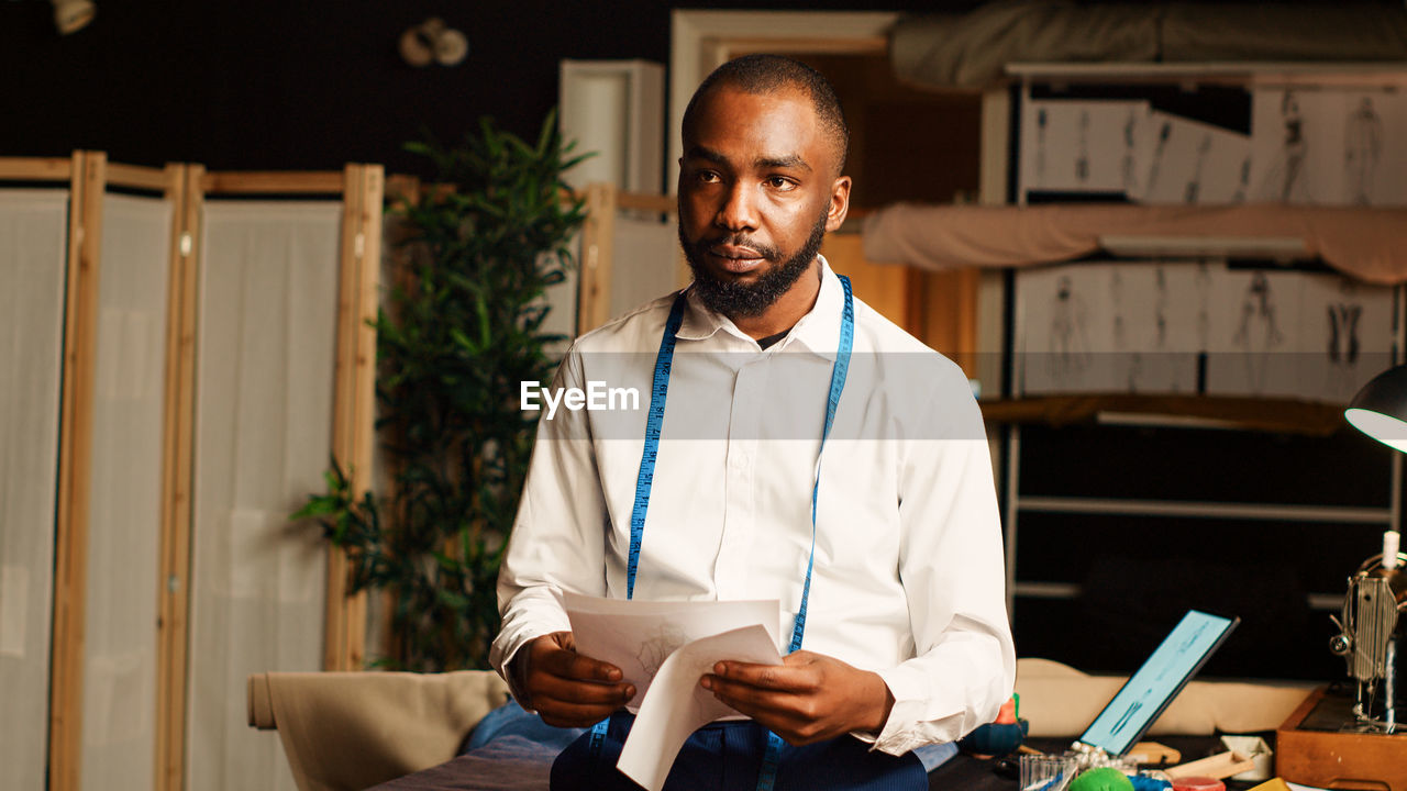 portrait of young man using digital tablet at home