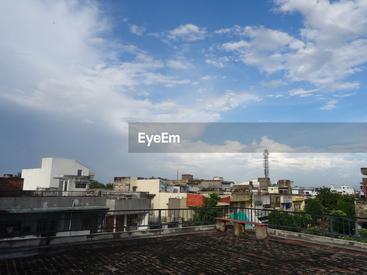 Buildings in city against cloudy sky