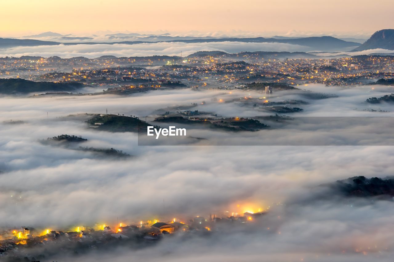 Aerial view of cityscape and cloudscape during sunset