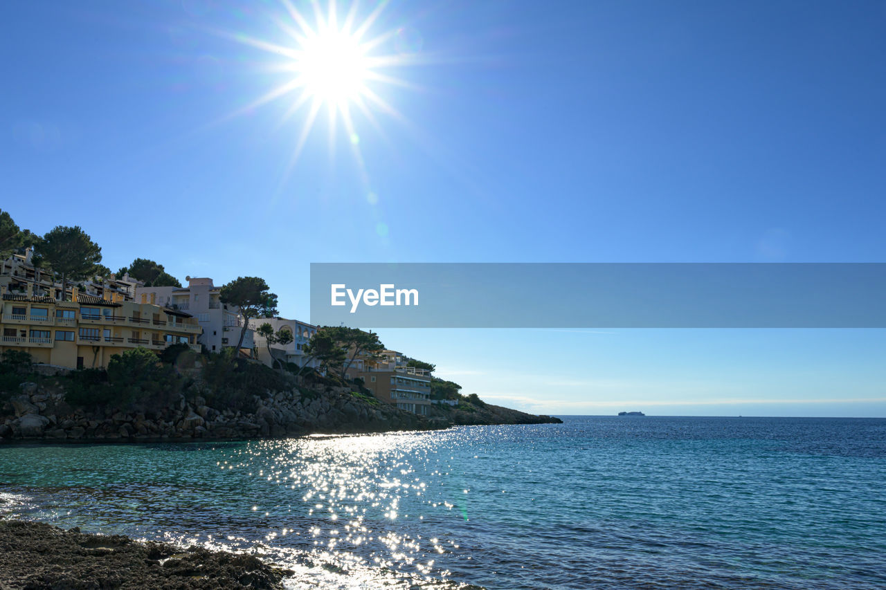 Scenic view of sea against sky on sunny day