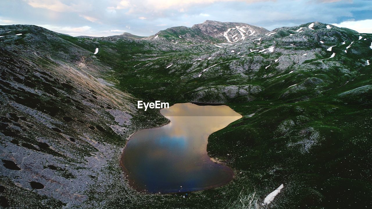 Scenic view of lake amidst mountains