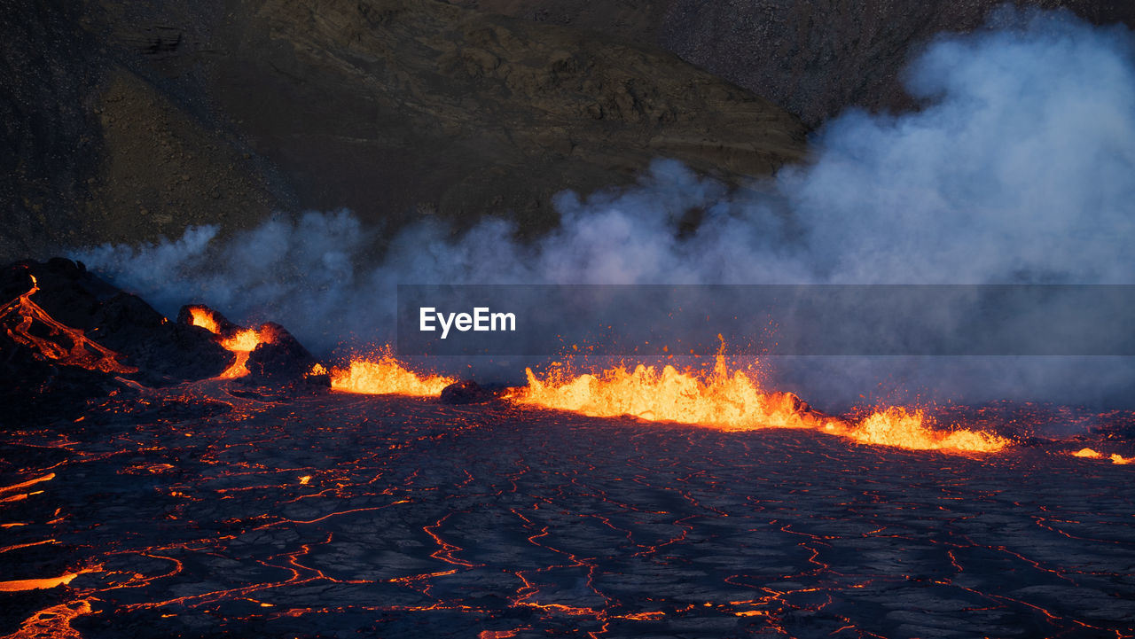 heat, lava, volcano, burning, land, environment, geology, fire, nature, mountain, smoke, landscape, sign, no people, communication, warning sign, accidents and disasters, flame, power in nature, night, outdoors, erupting, glowing, motion, active volcano, wildfire, beauty in nature