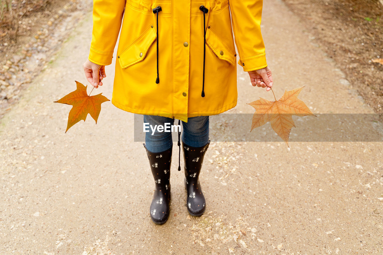 low section of woman walking on road