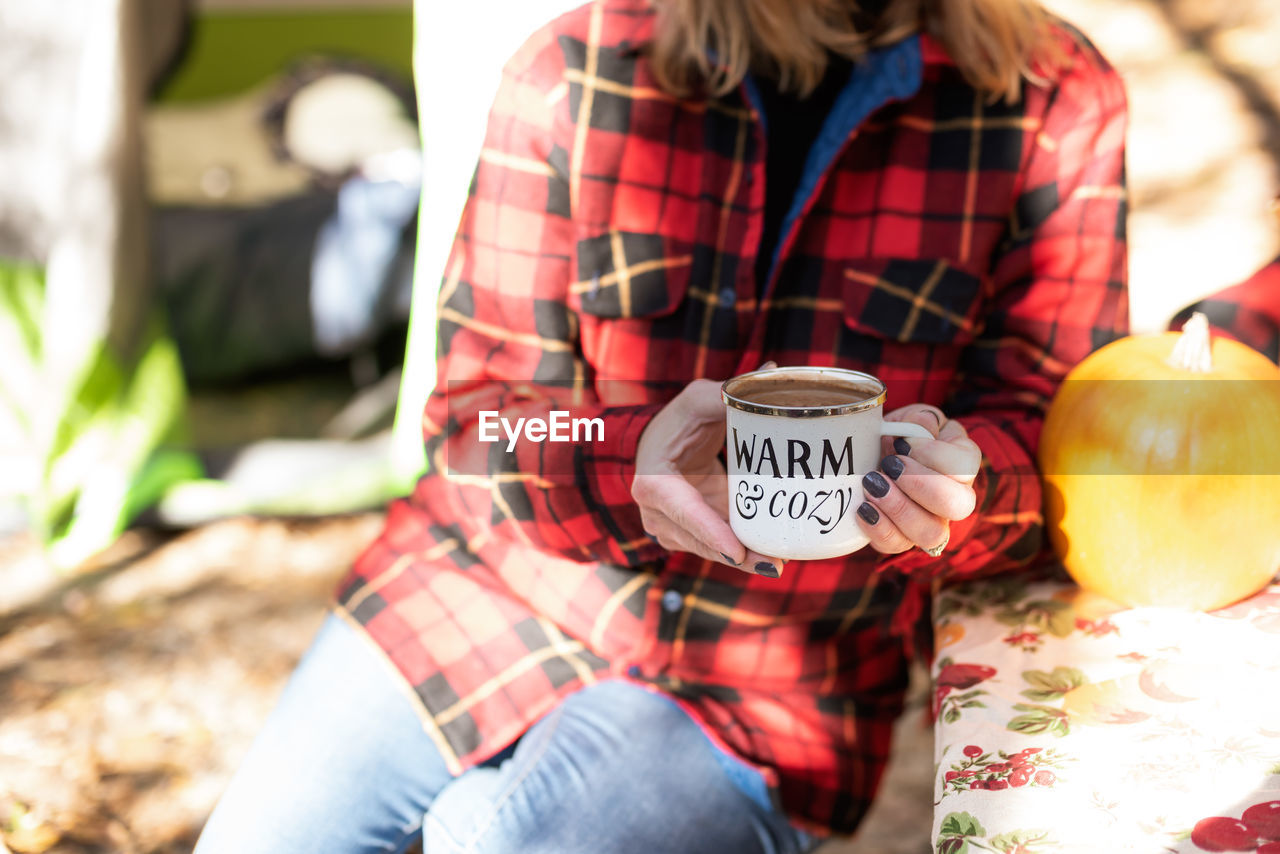 Midsection of woman sitting on bench