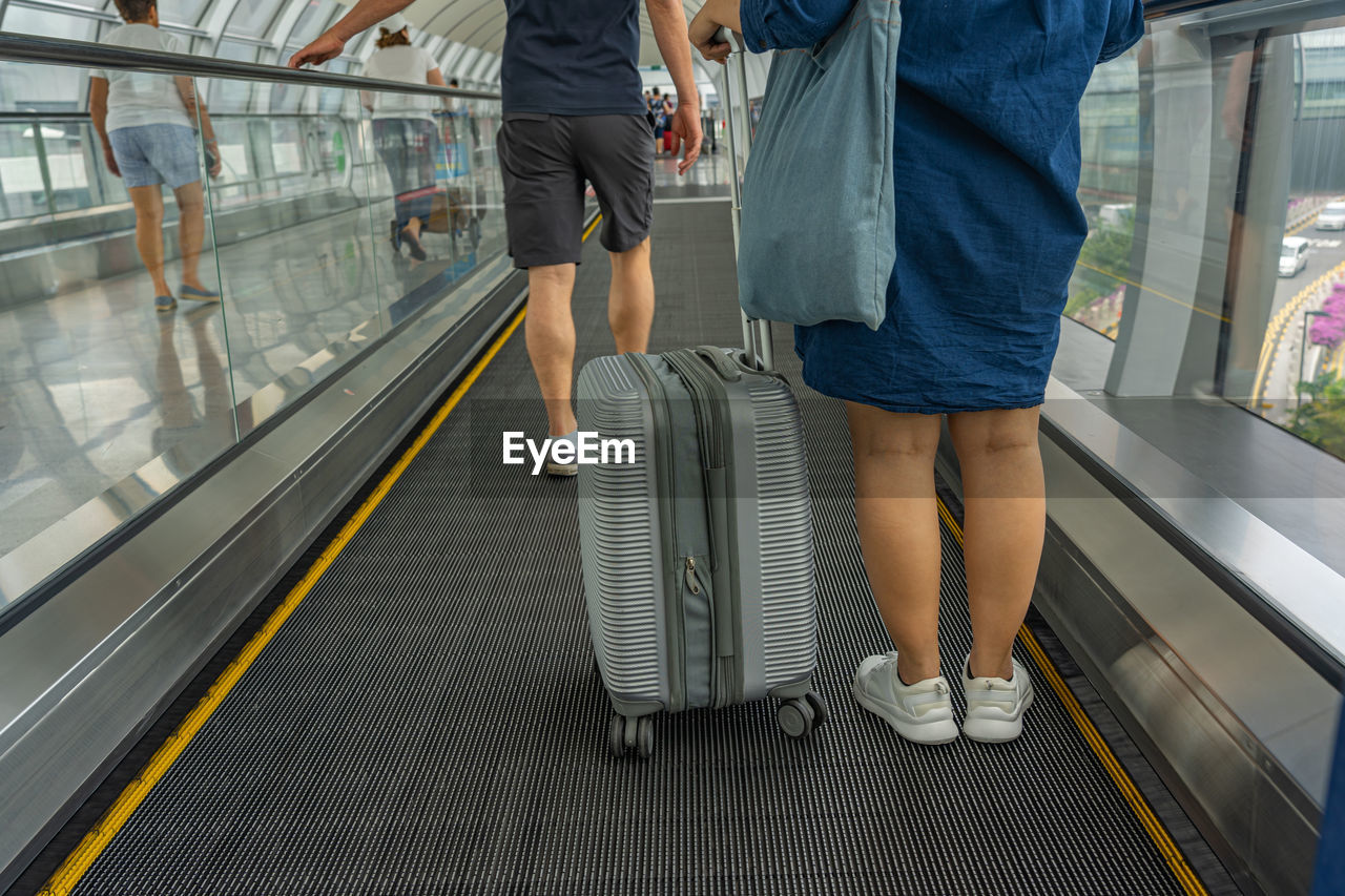 Low section of people walking on railway station platform