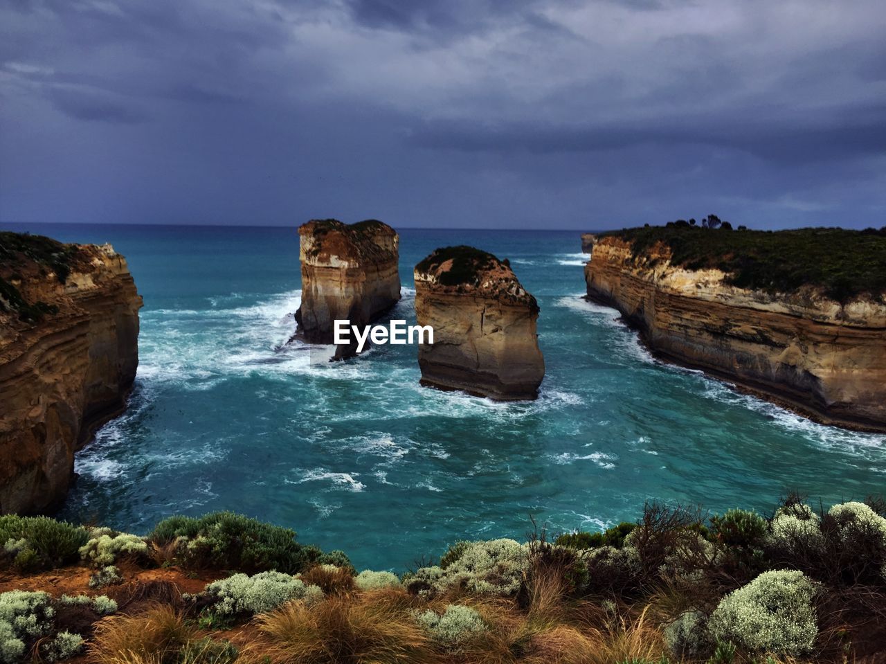 Rock formation on sea against sky