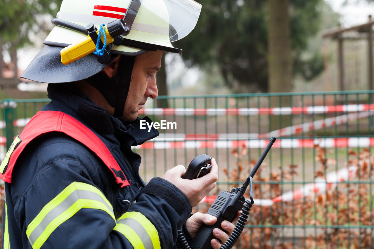 Firefighter using walkie-talkie