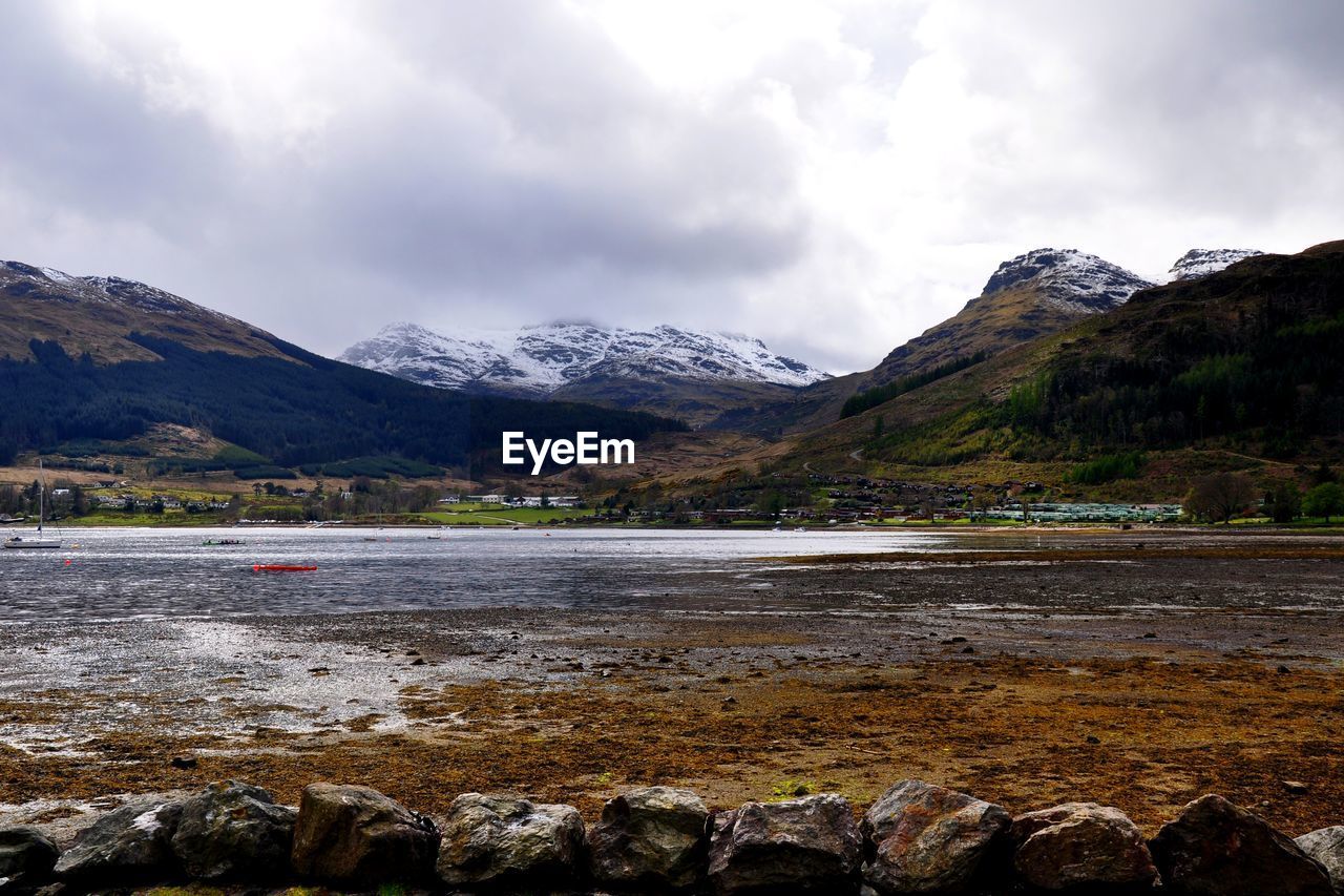 Scenic view of loch goil and mountains against cloudy sky