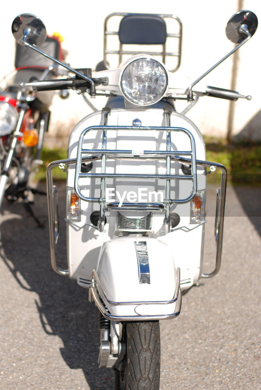 CLOSE-UP OF BICYCLE PARKED ON STREET