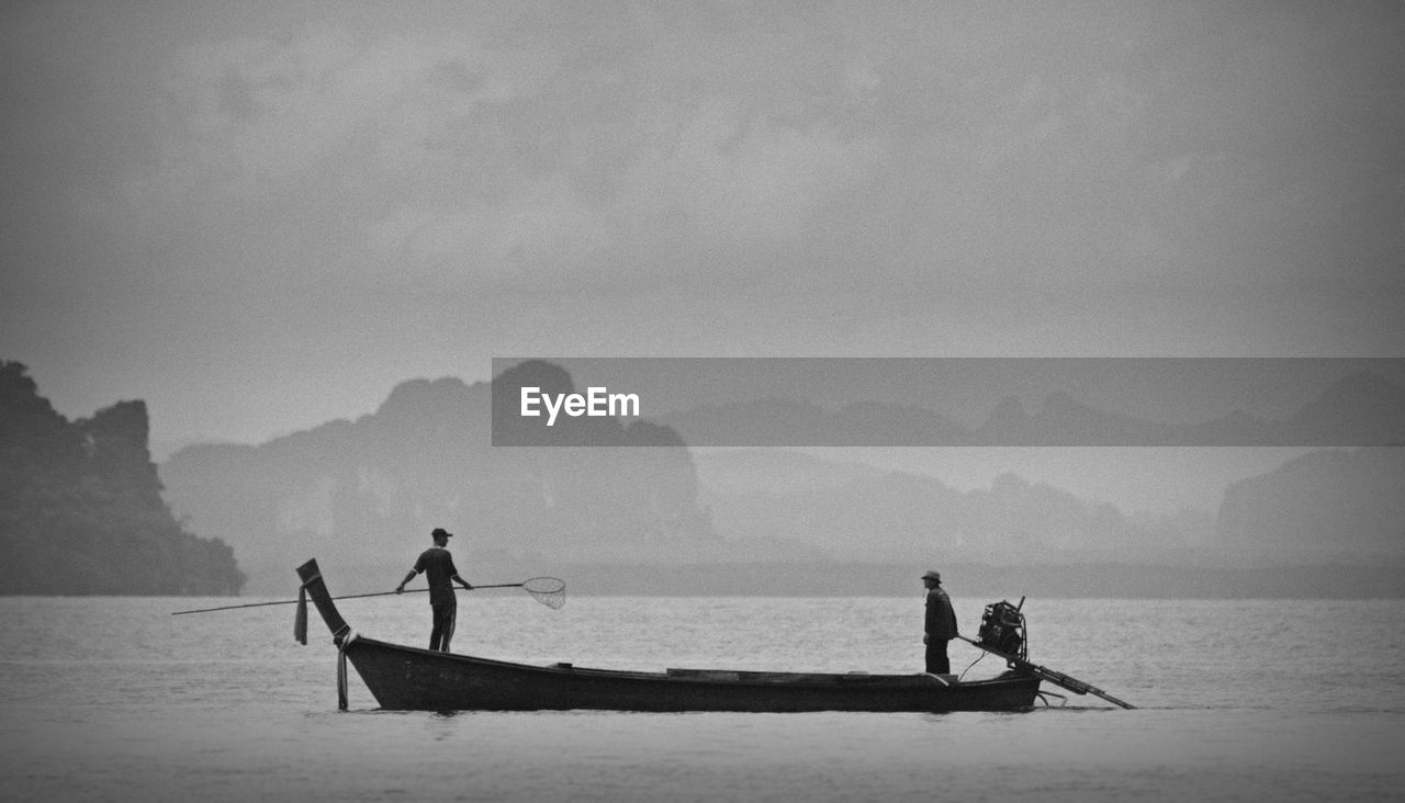 MEN FISHING ON BEACH