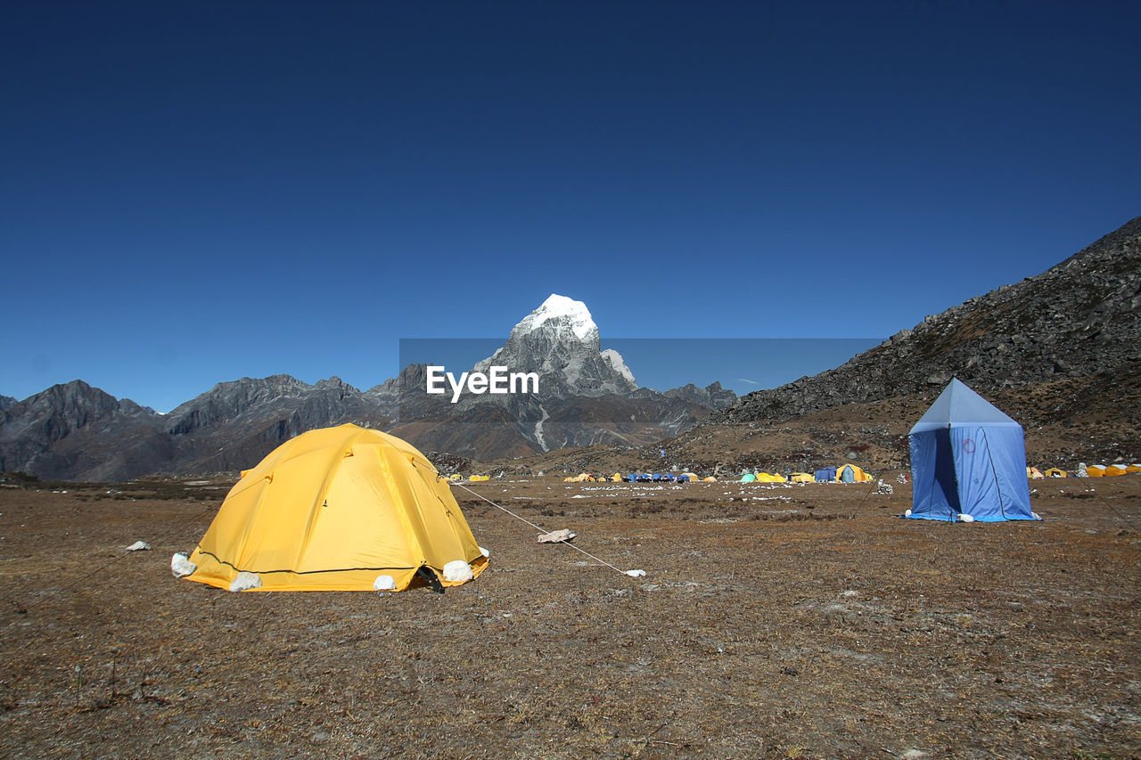 TENT ON MOUNTAIN ROAD AGAINST CLEAR SKY