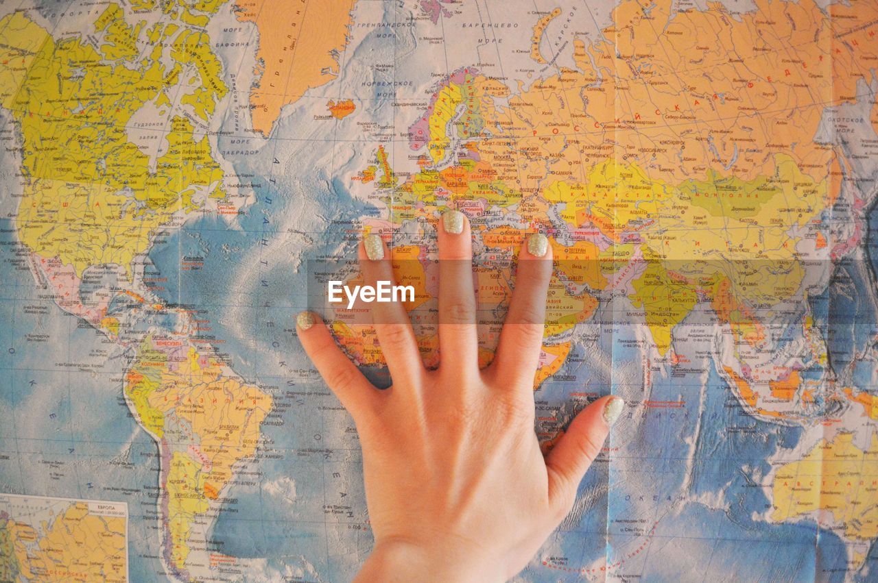 Woman's hand on the world map