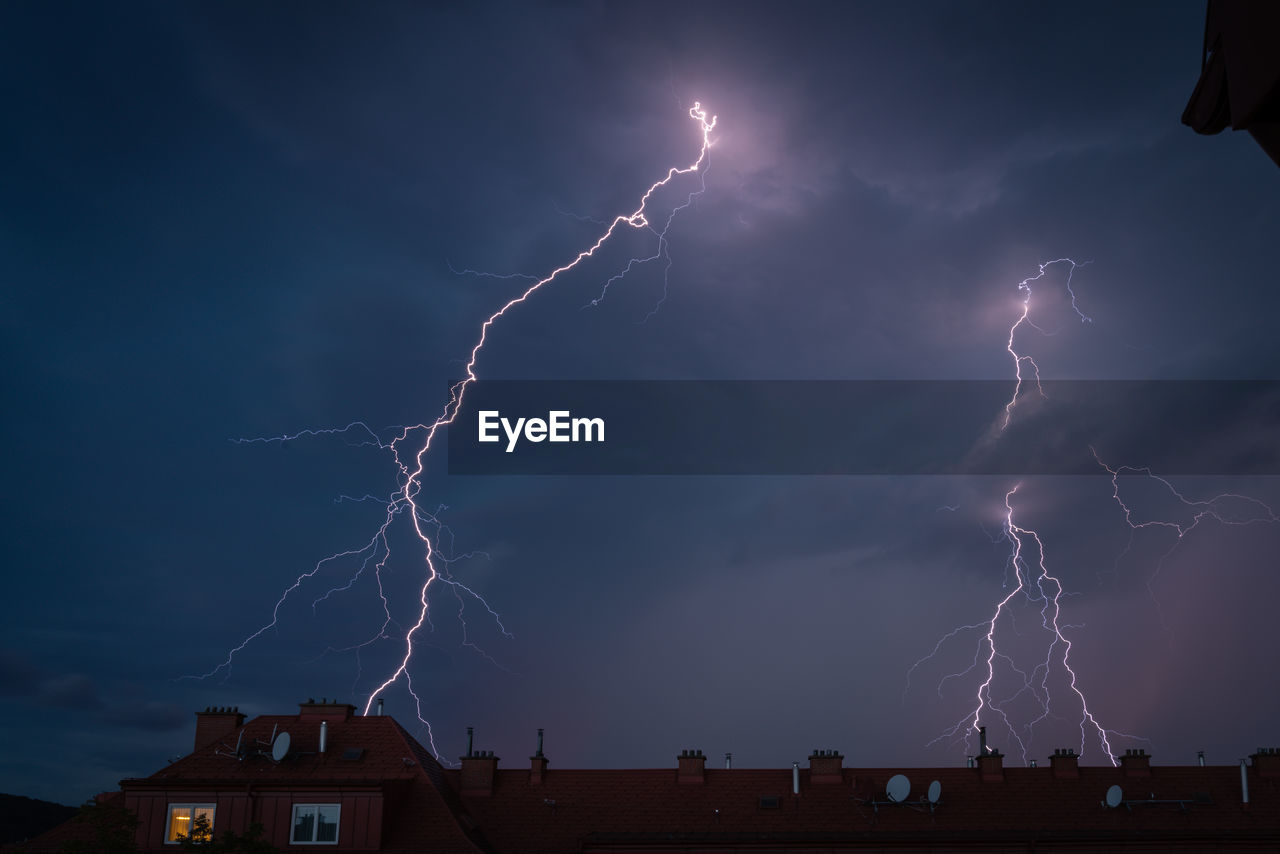 Low angle view of lightning against sky at night