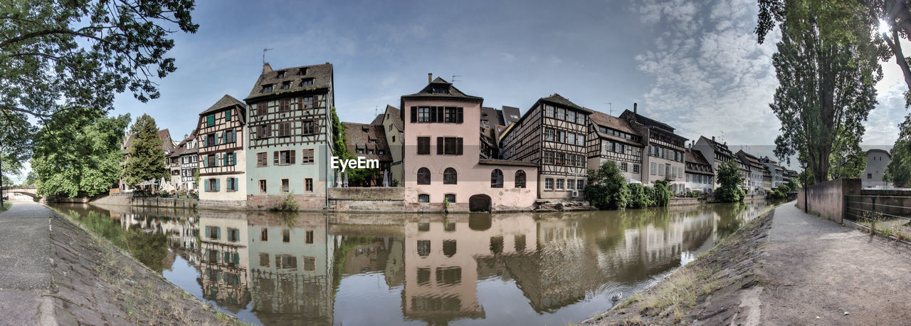 Panoramic view of lake and buildings against sky