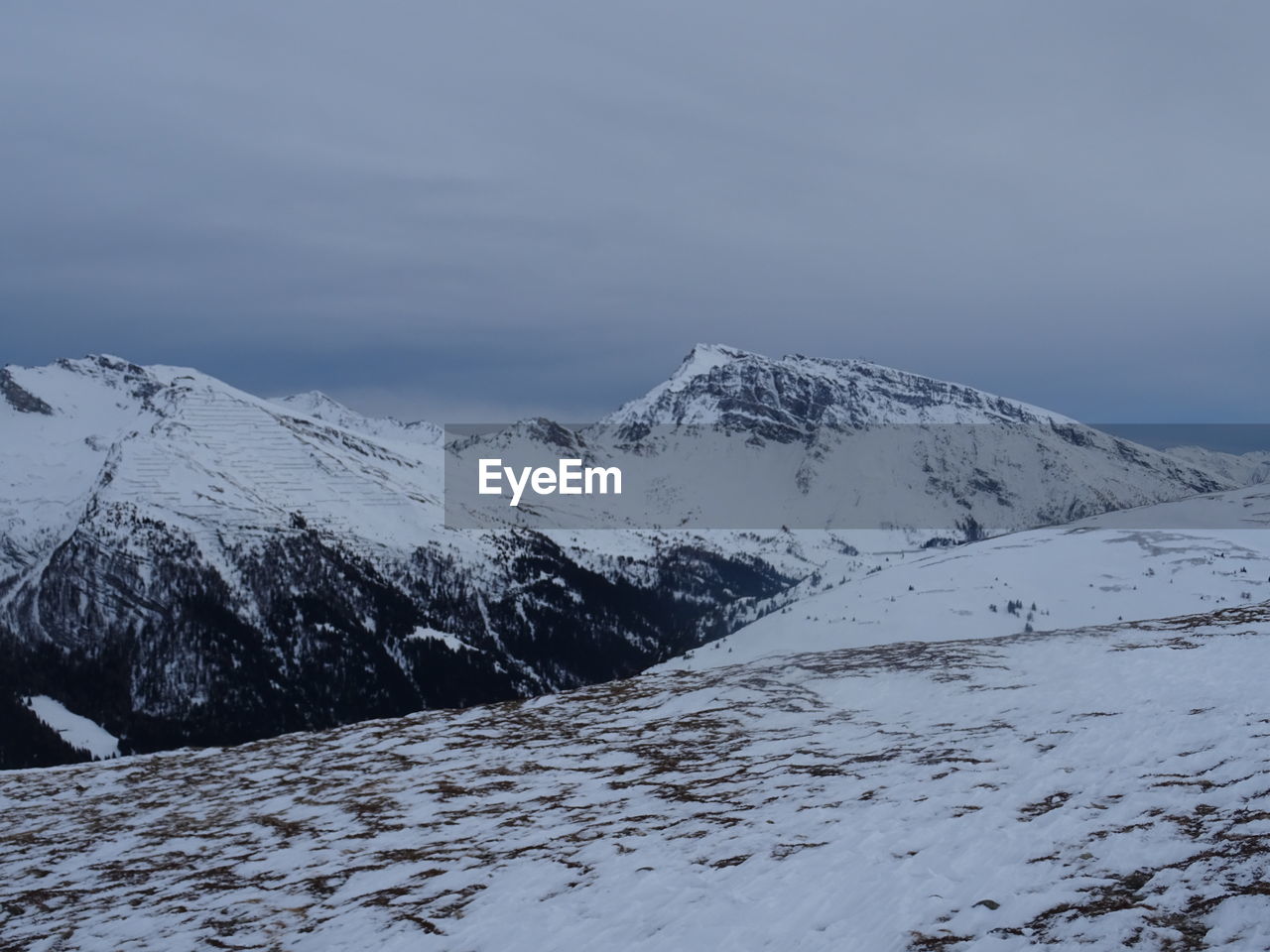 Scenic view of snow covered mountains against sky