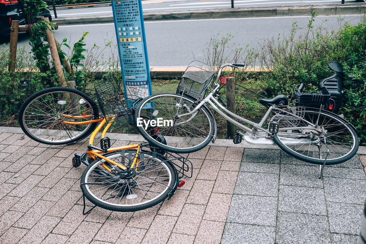 BICYCLE PARKED BY RAILING