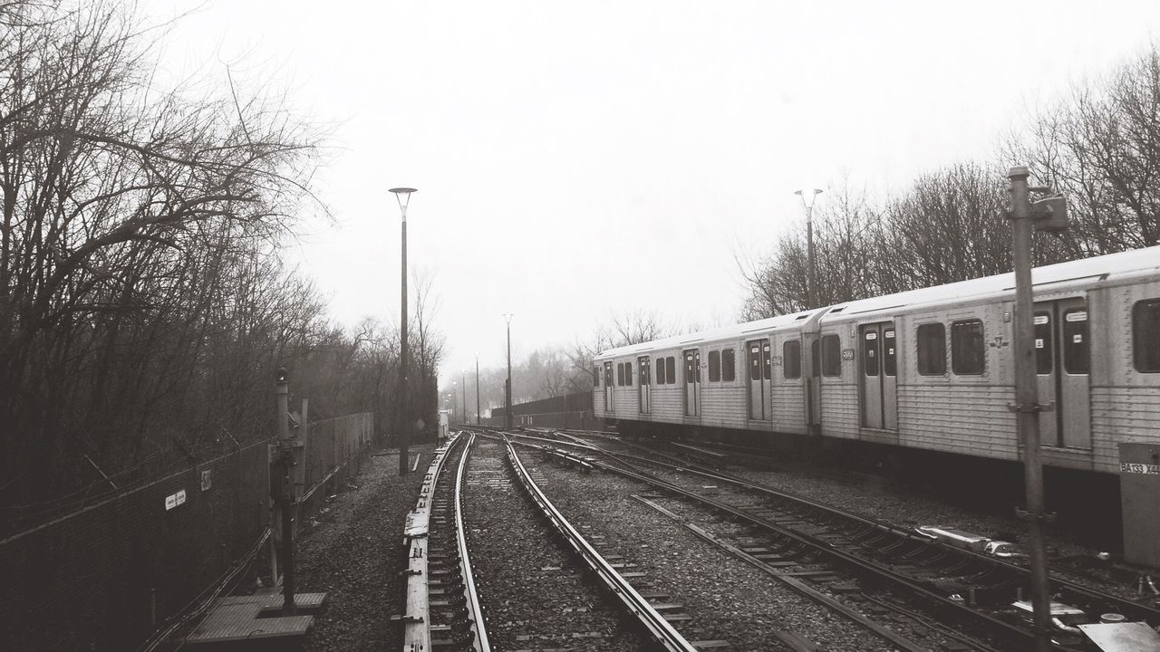 Railroad track with trees in background