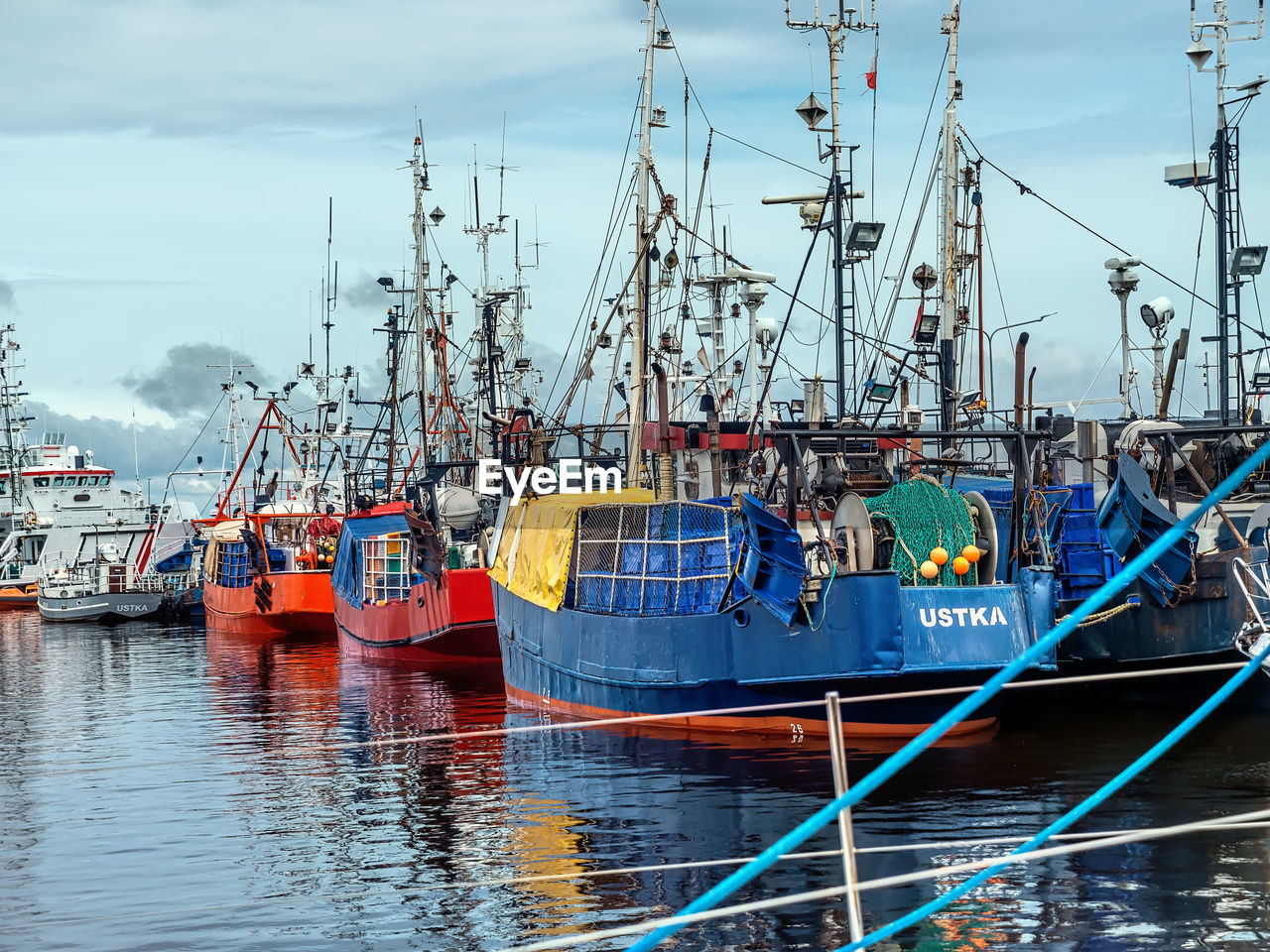 BOATS MOORED AT HARBOR