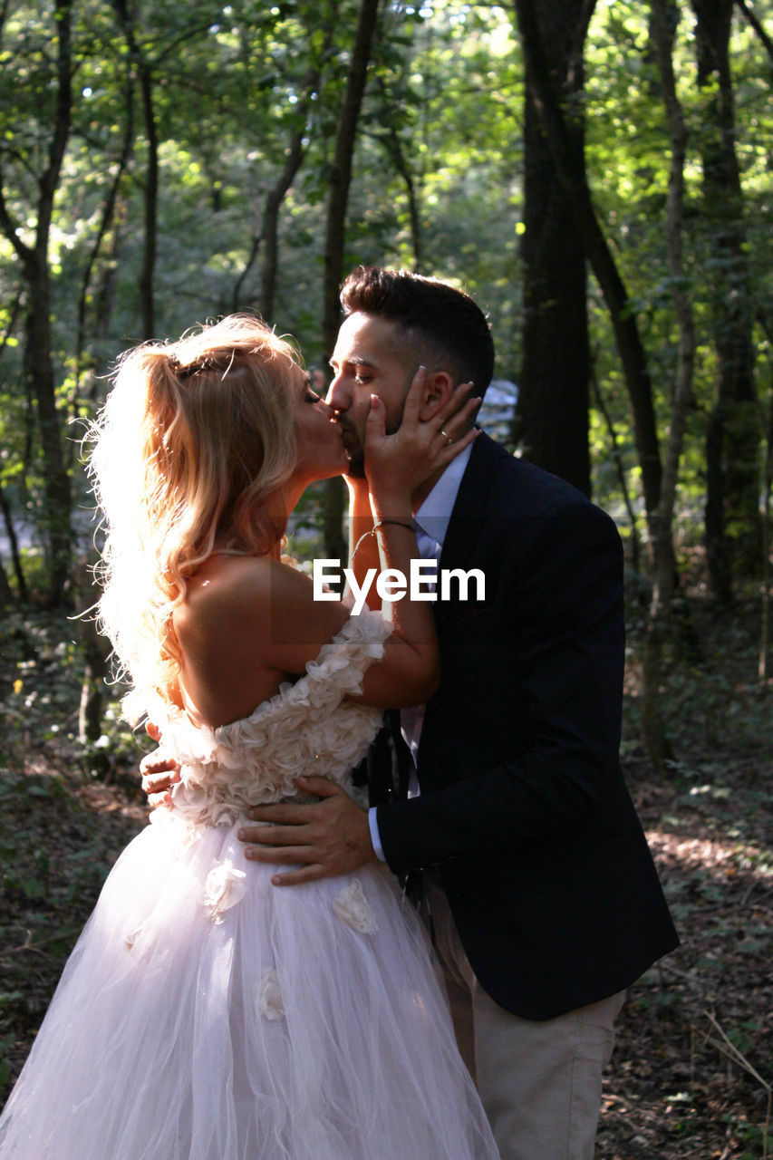 Young couple kissing in park