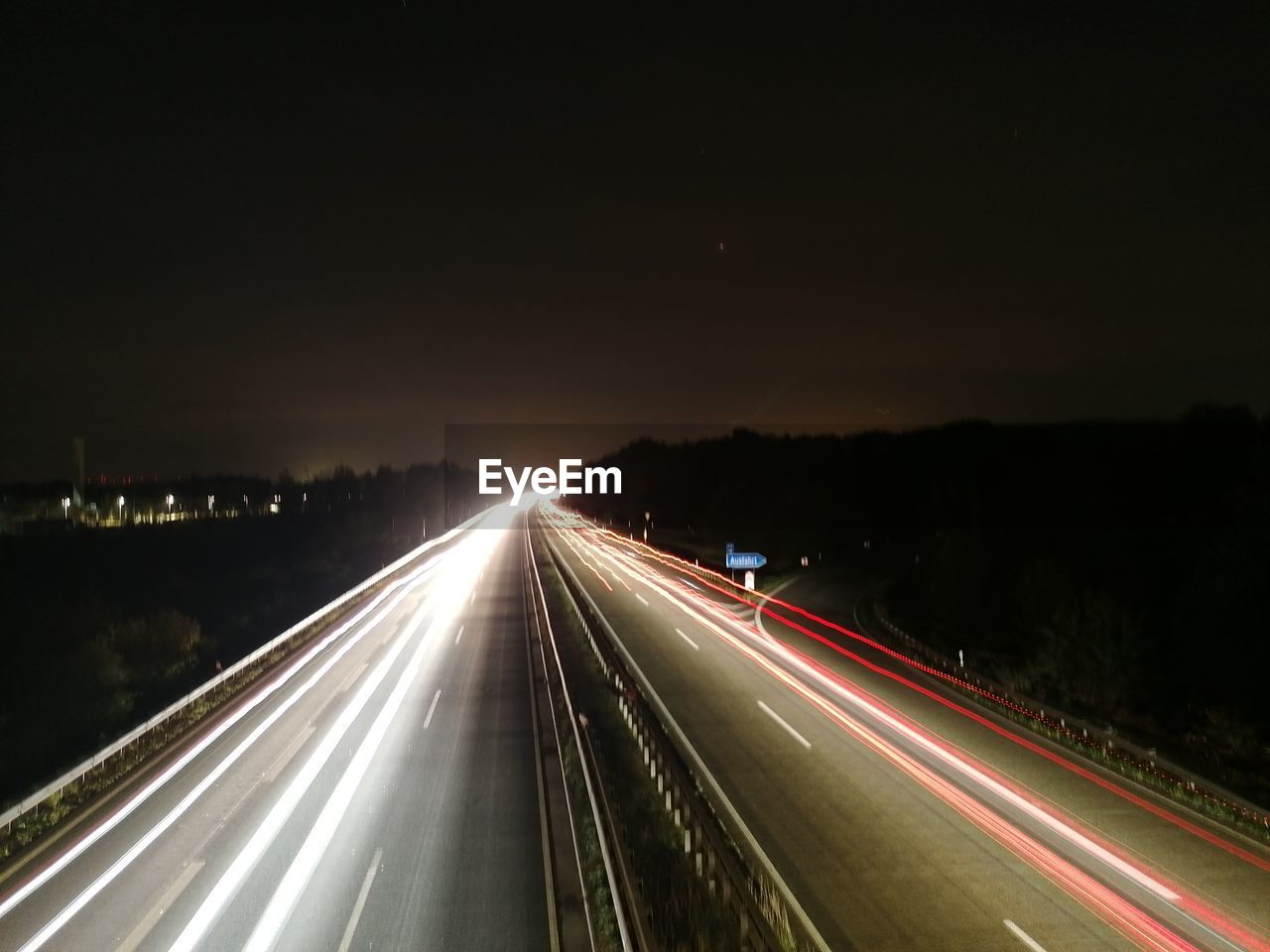 transportation, light trail, motion, night, long exposure, speed, illuminated, road, highway, traffic, blurred motion, city, tail light, mode of transportation, street, darkness, light, headlight, the way forward, motor vehicle, infrastructure, architecture, on the move, sky, no people, car, nature, lighting equipment, light - natural phenomenon, street light, multiple lane highway, travel, vehicle light, city life, outdoors, sign, vanishing point, high angle view, city street, symbol, land vehicle, built structure, travel destinations, glowing, lane, dark