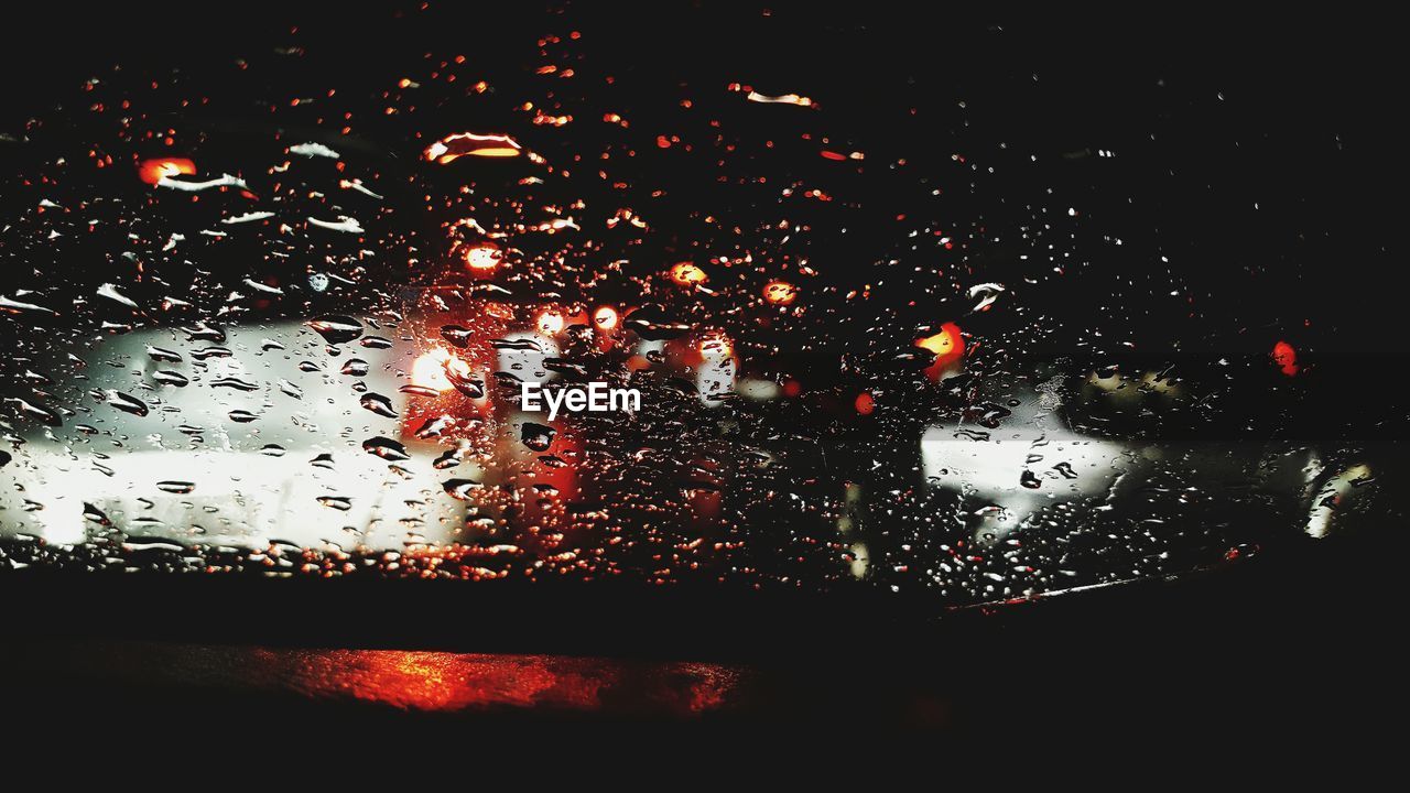 Close-up of wet car windshield at night