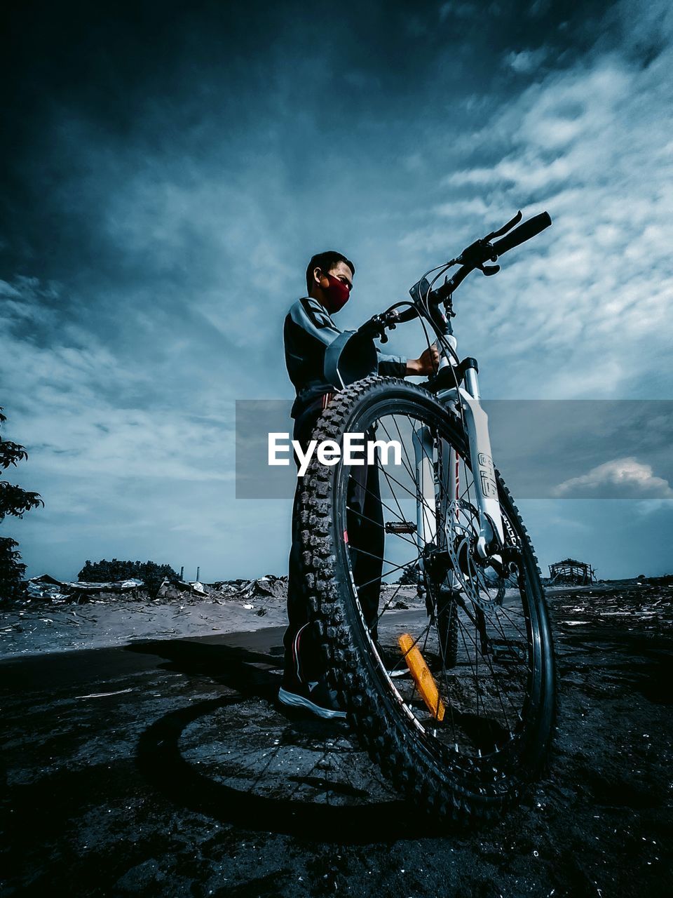 Man on bicycle against sky