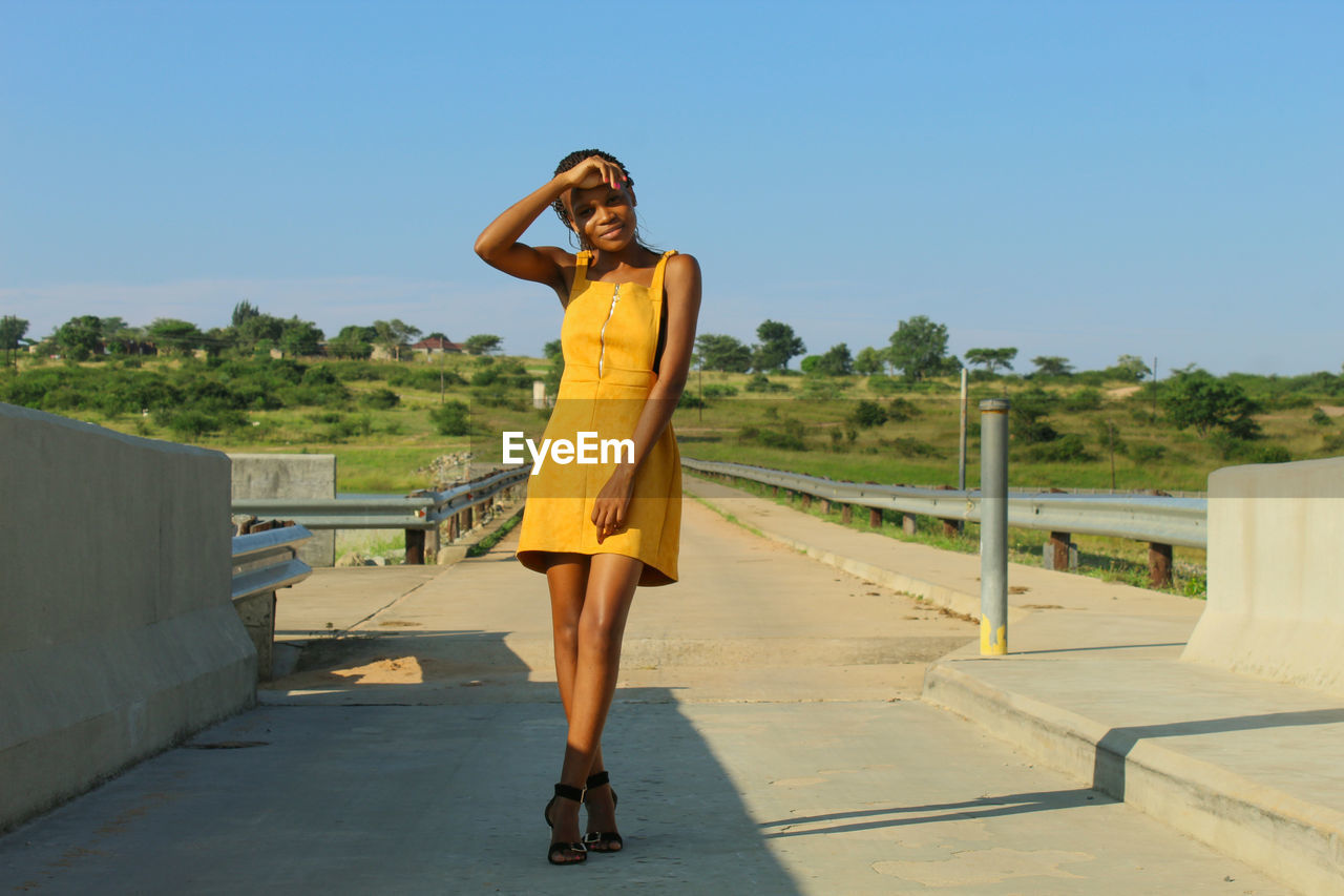 Full length of woman standing against clear sky