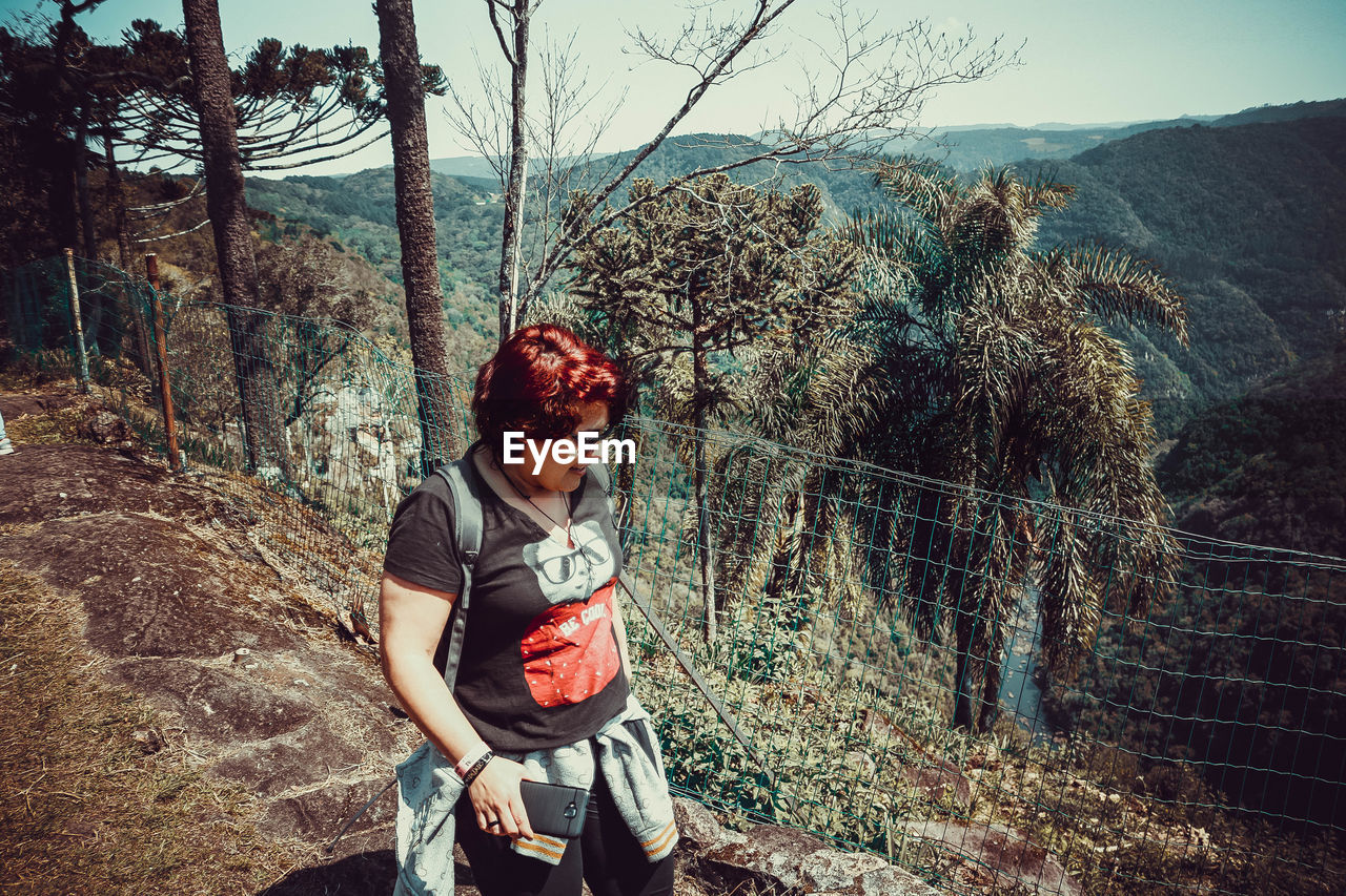 Woman walking on mountain in forest