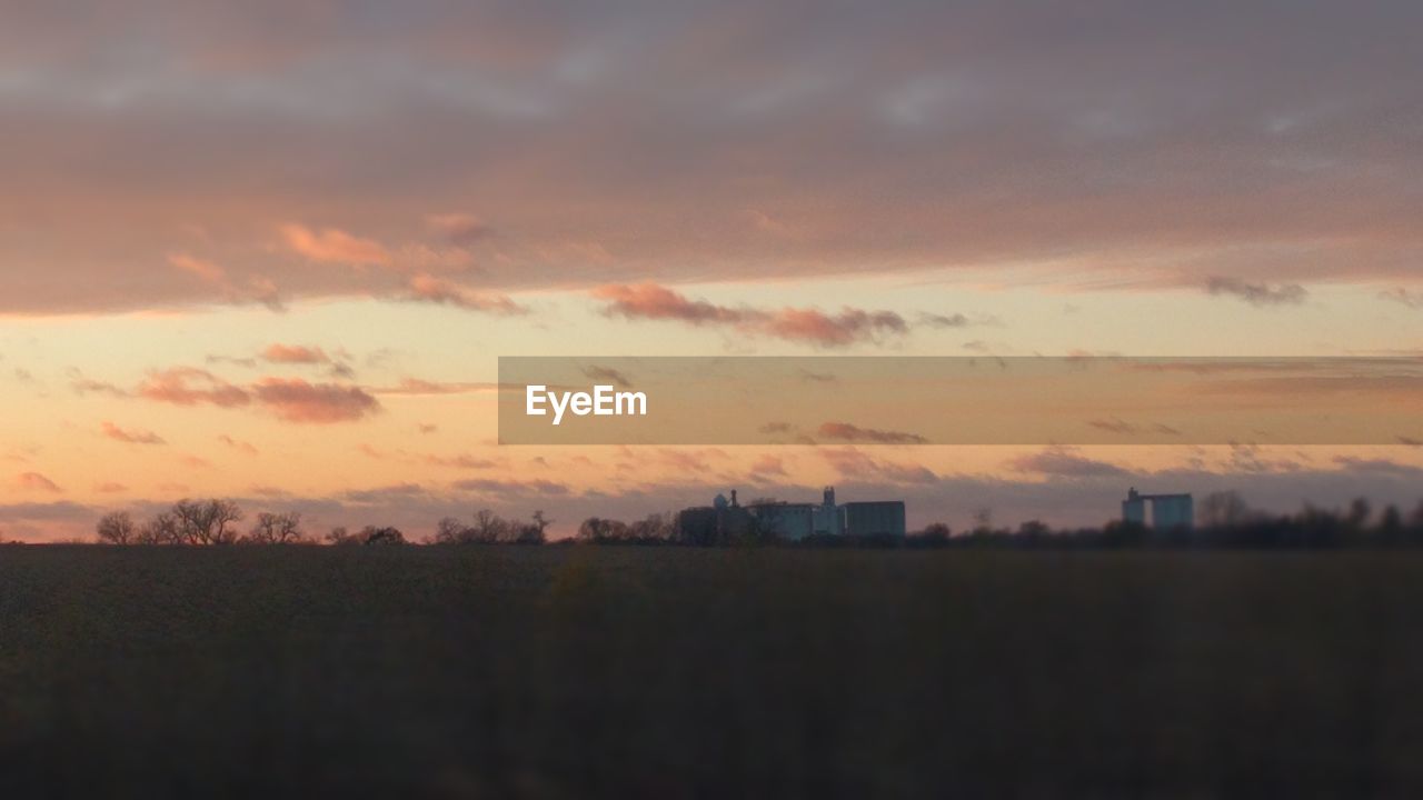 SILHOUETTE FIELD AGAINST SKY DURING SUNSET