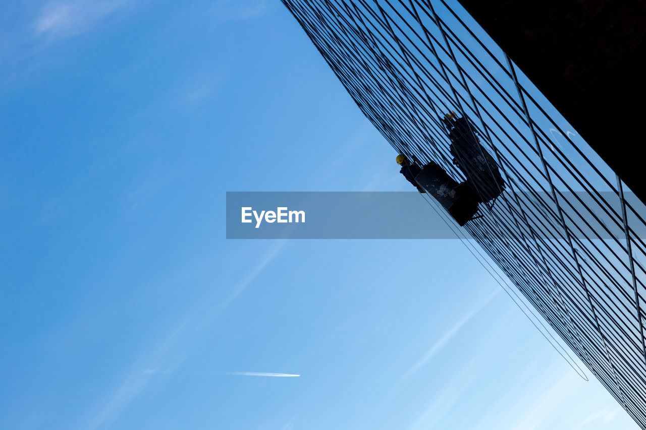 LOW ANGLE VIEW OF BUILT STRUCTURES AGAINST BLUE SKY