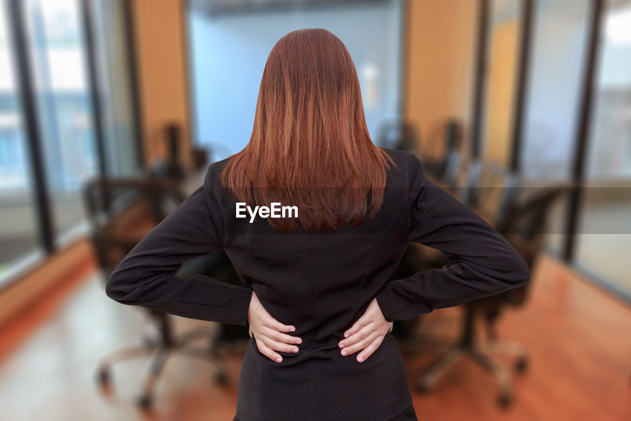 Rear view of businesswoman standing in office