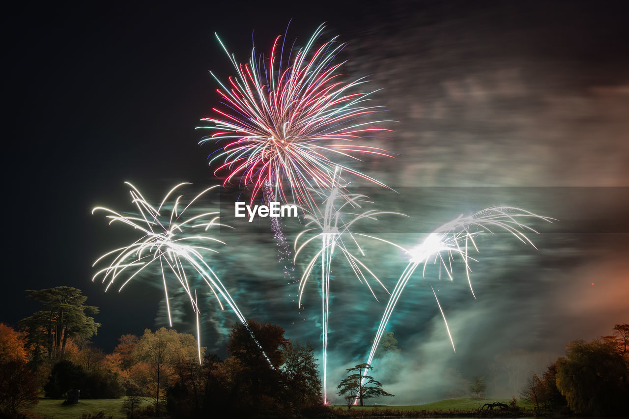 Low angle view of firework display at night