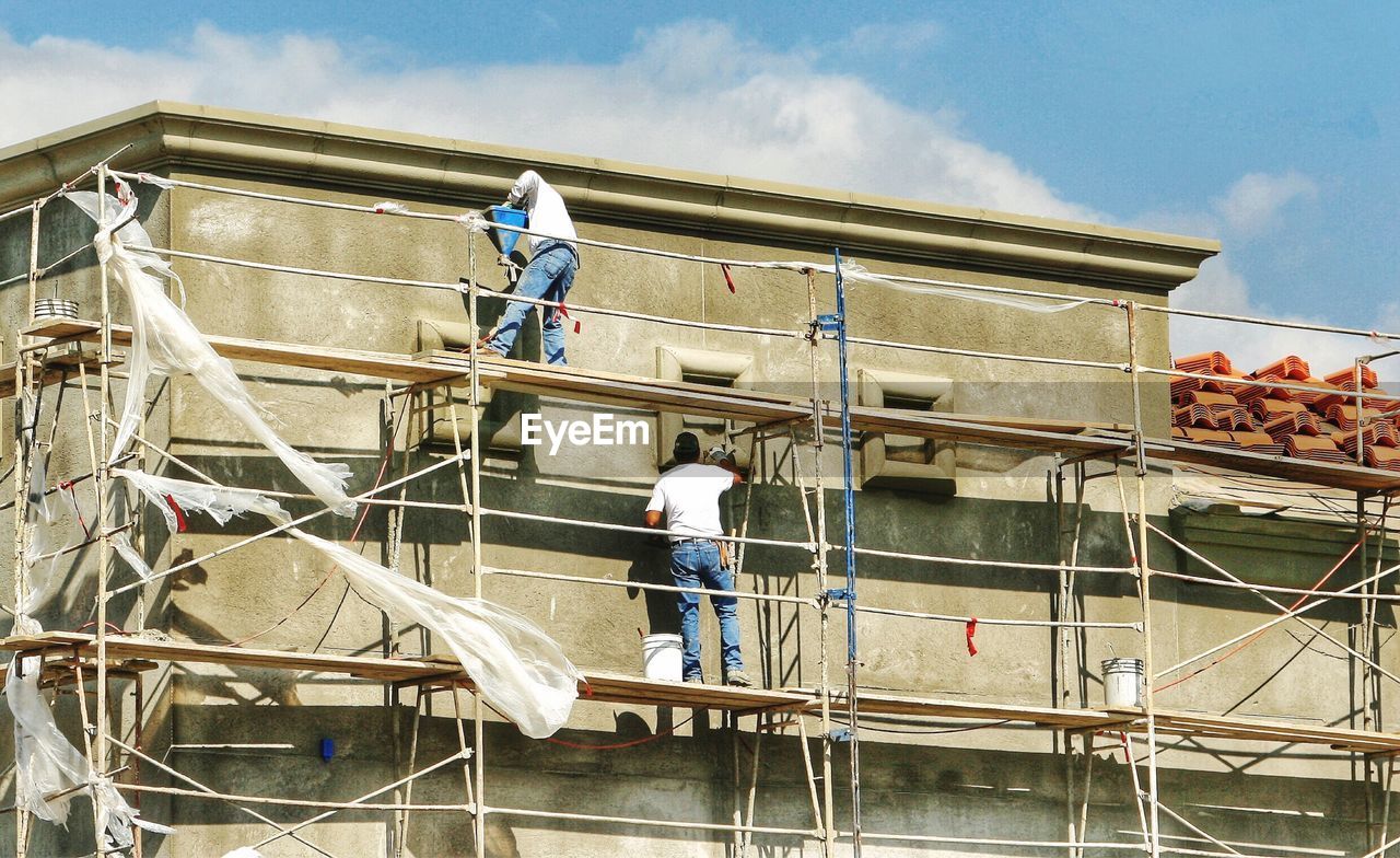 Low angle view of workers working at construction site