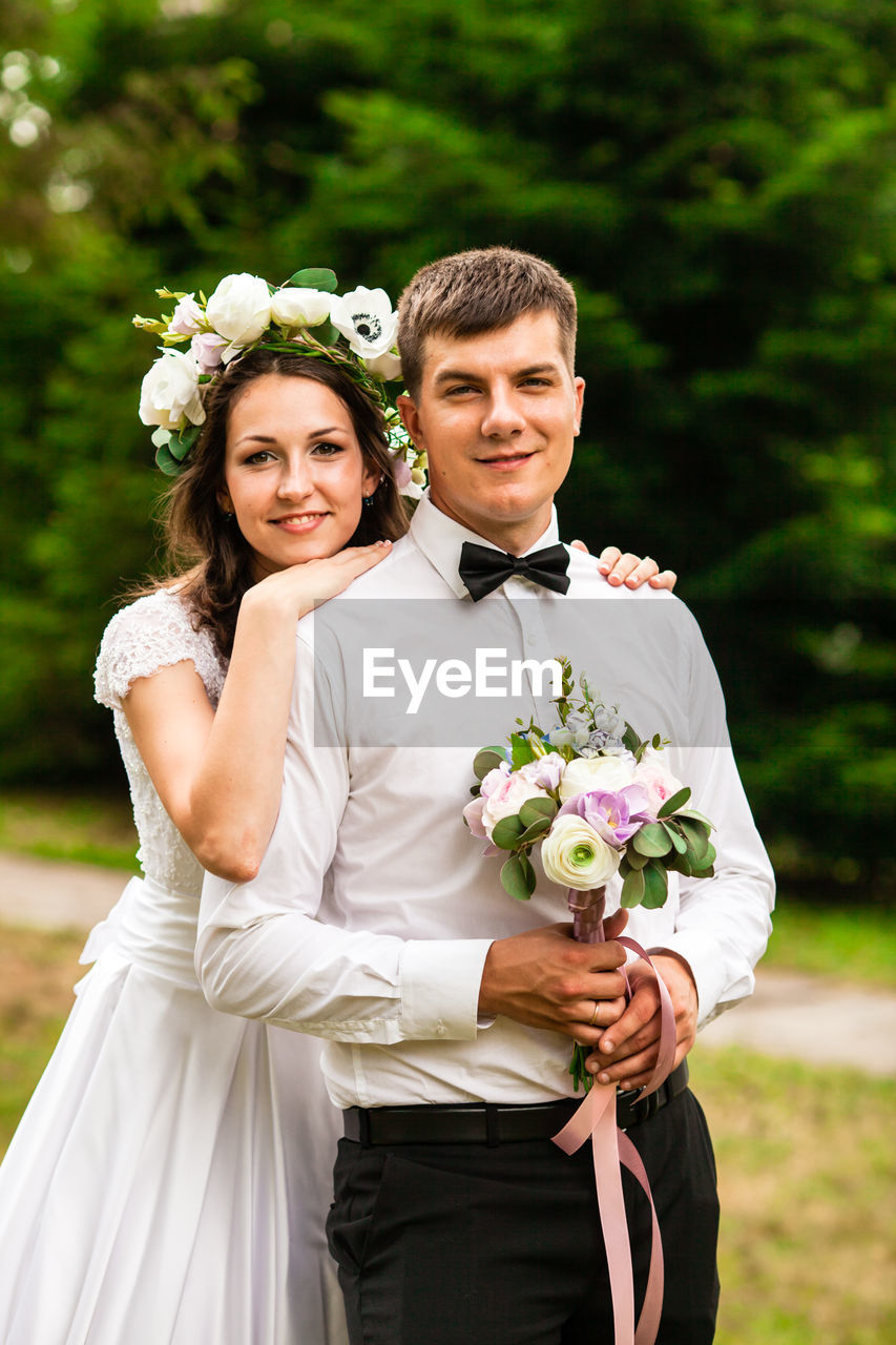 portrait of smiling young woman wearing wedding dress