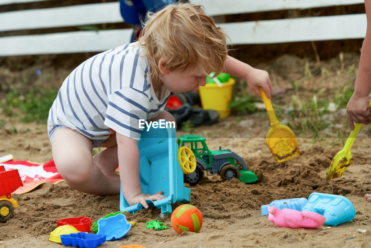 high angle view of boy playing with toys on field