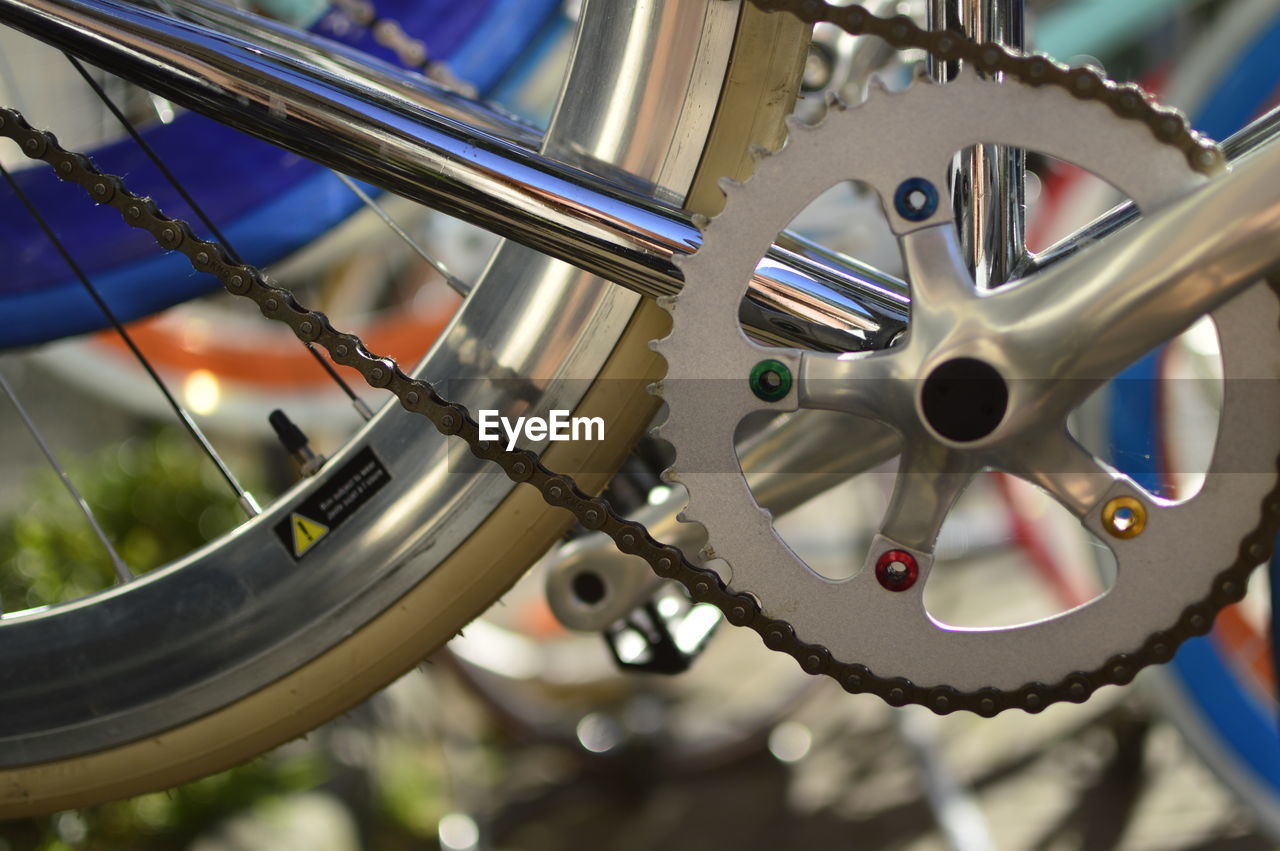 CLOSE-UP OF BICYCLE WHEEL IN CITY