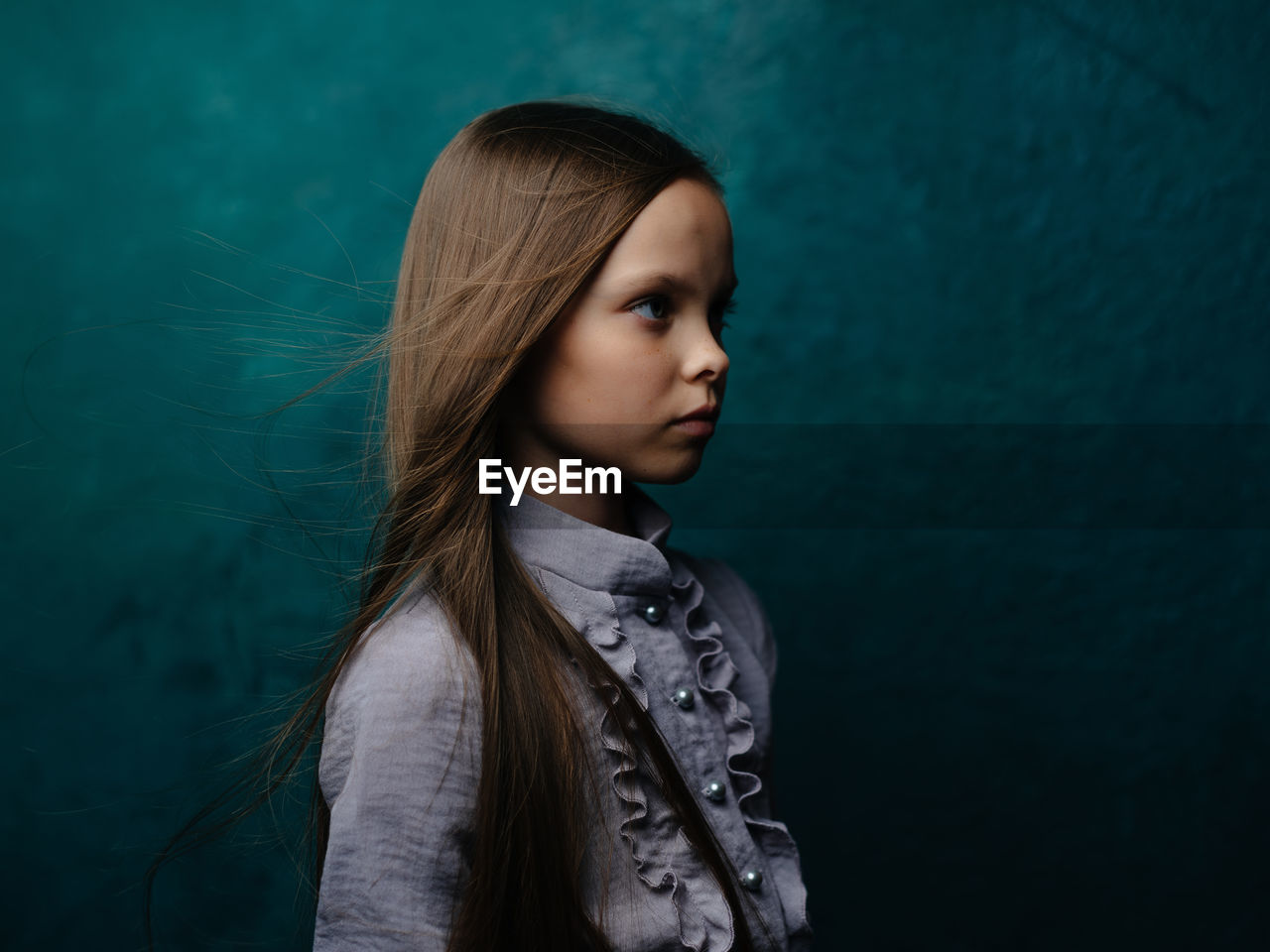 Portrait of girl standing against water