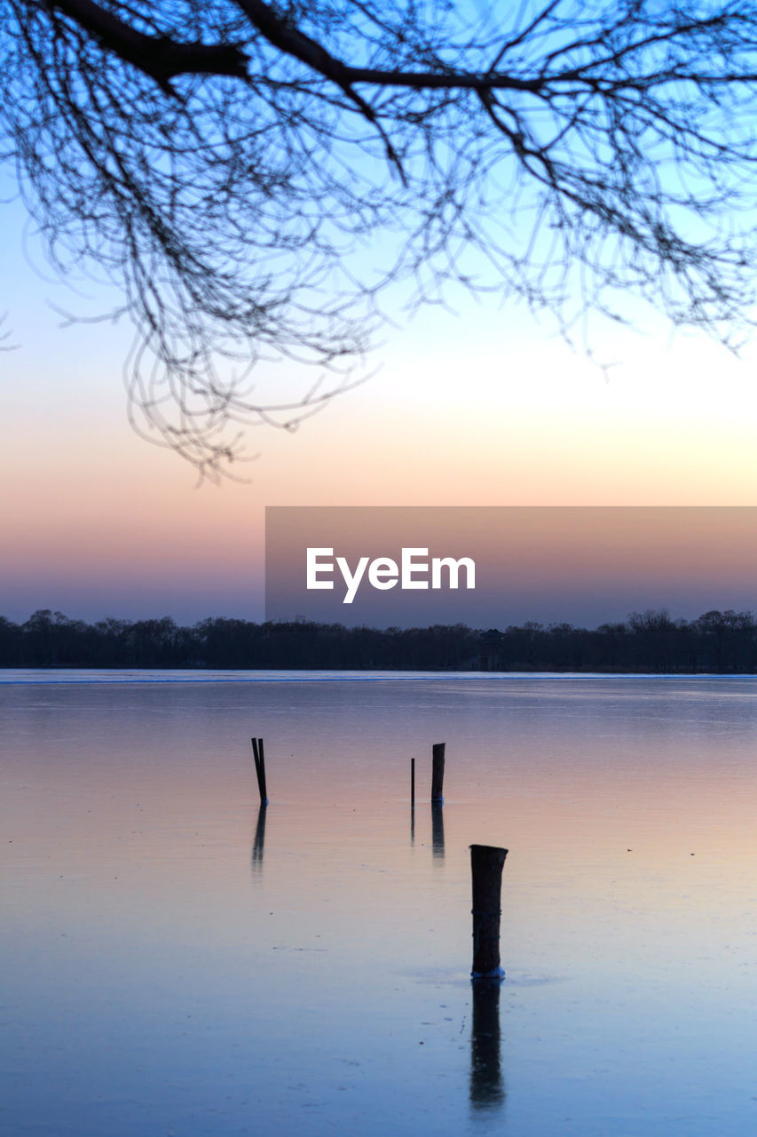 Scenic view of lake at sunset