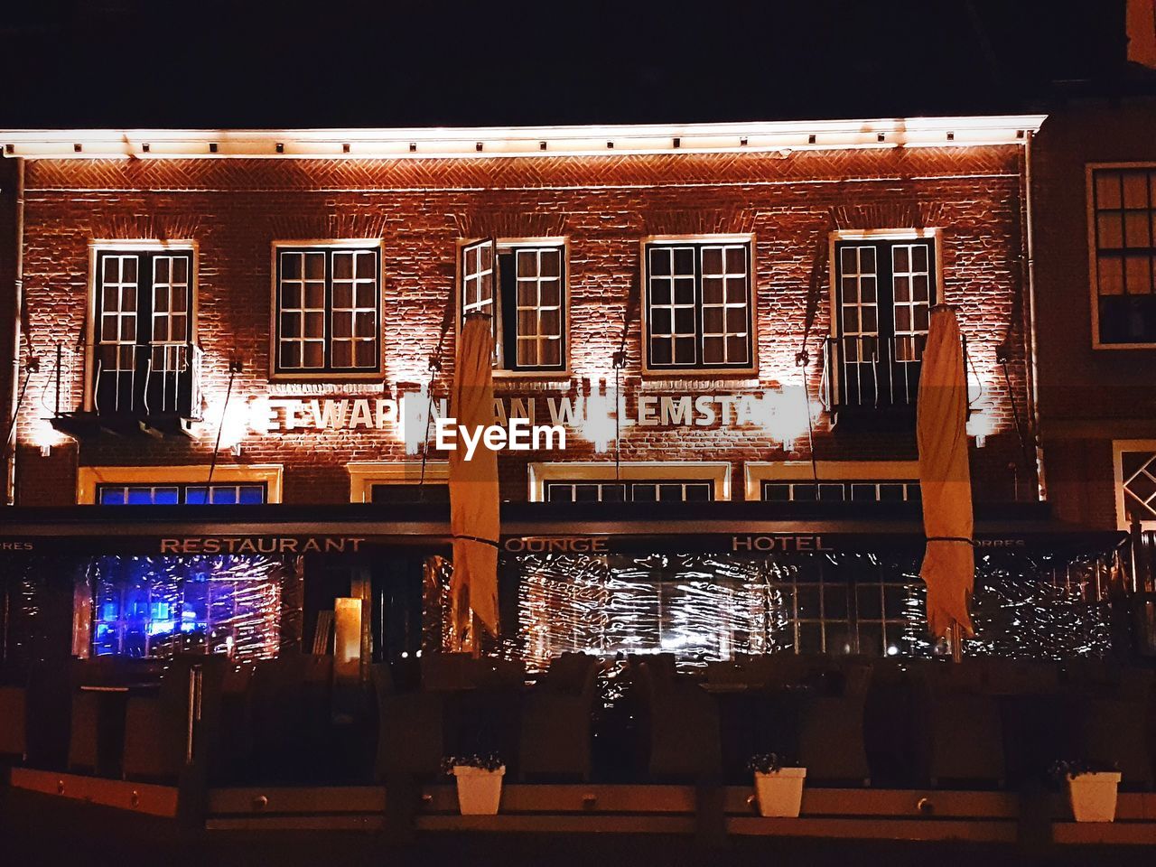 ILLUMINATED BUILDING AGAINST SKY