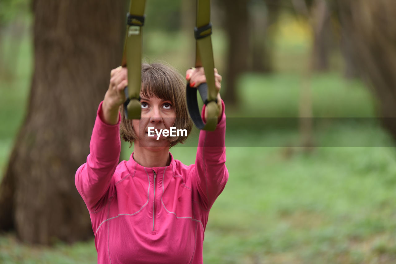 Mid adult woman exercising at public park