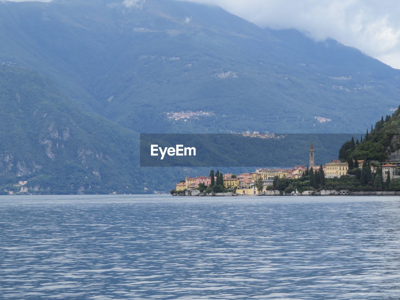 SEA BY BUILDINGS IN CITY AGAINST SKY