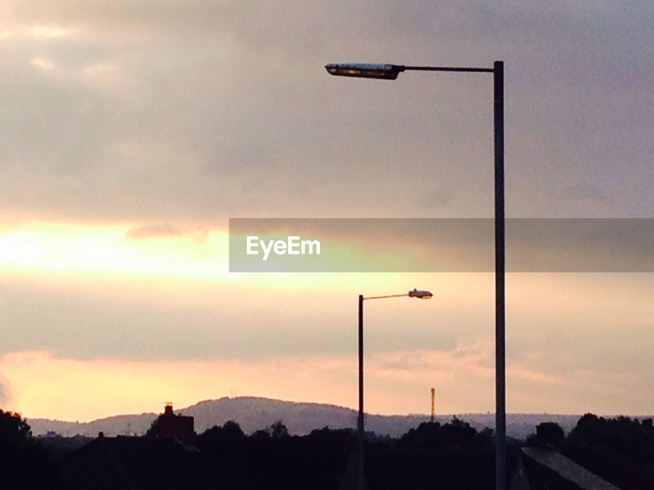 LOW ANGLE VIEW OF STREET LIGHT AT SUNSET