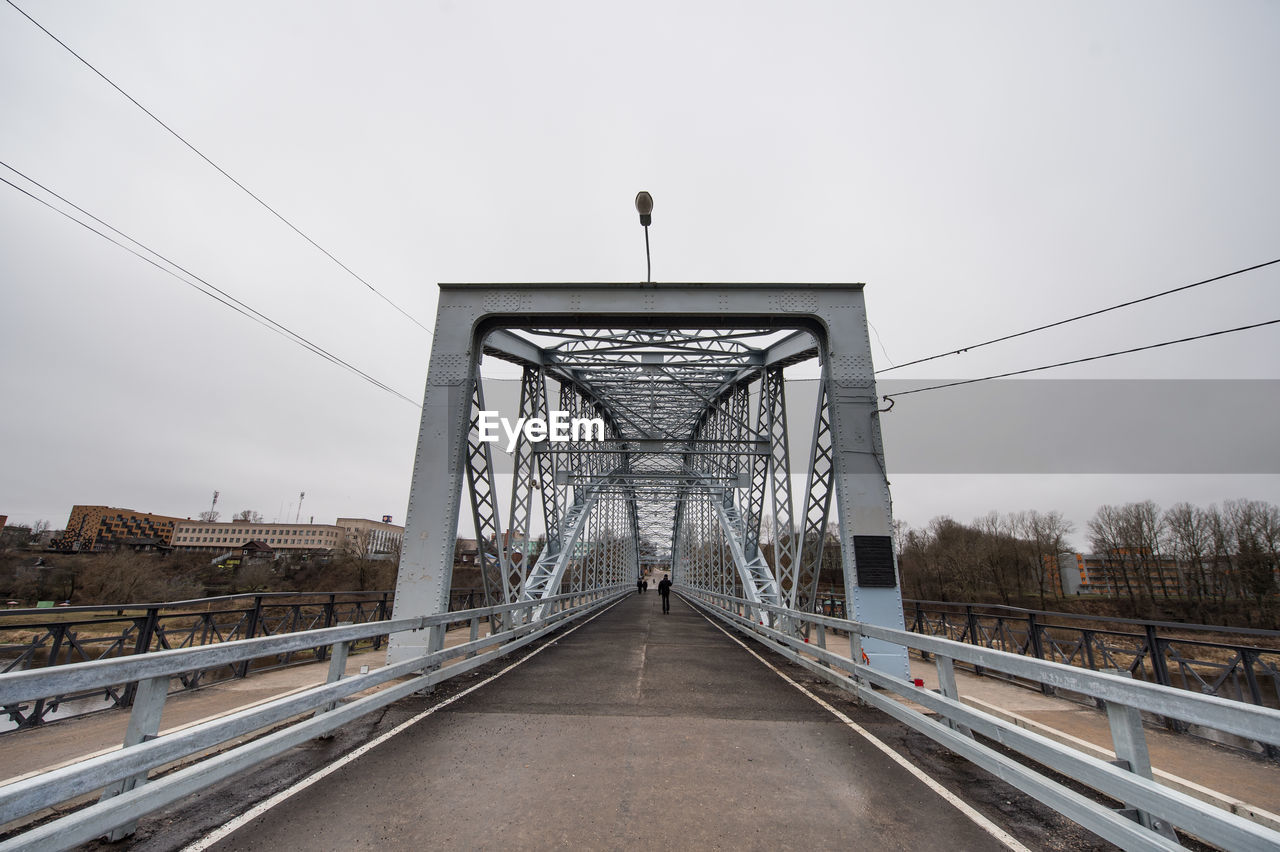 bridge, architecture, transportation, built structure, sky, transport, city, road, nature, the way forward, highway, travel destinations, overpass, travel, no people, track, outdoors, street, day, mode of transportation, vanishing point, cloud, rail transportation, diminishing perspective, railroad track, cable, tourism, building exterior, landscape, city life, fog, cityscape, suspension bridge