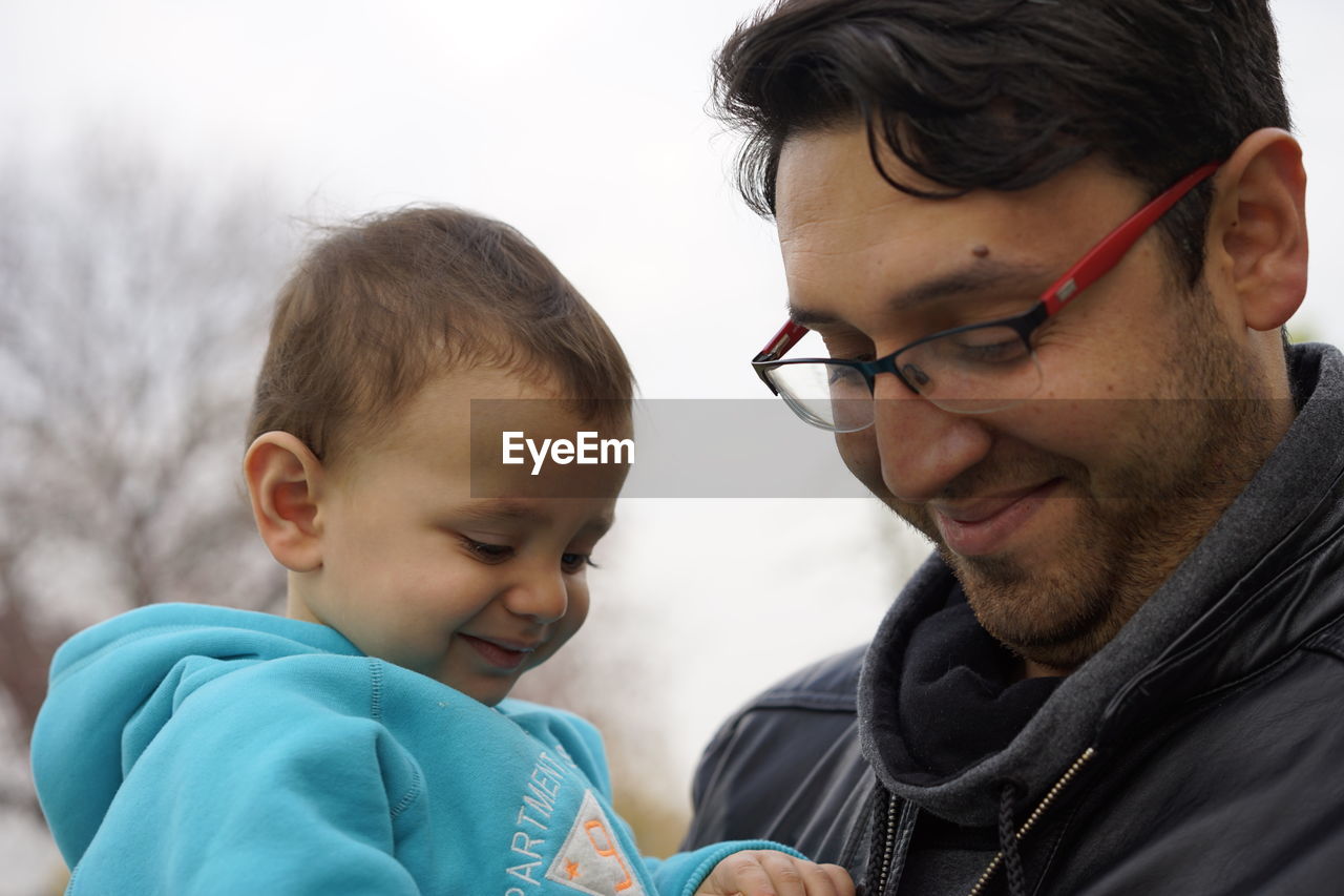 Close-up portrait of father and son