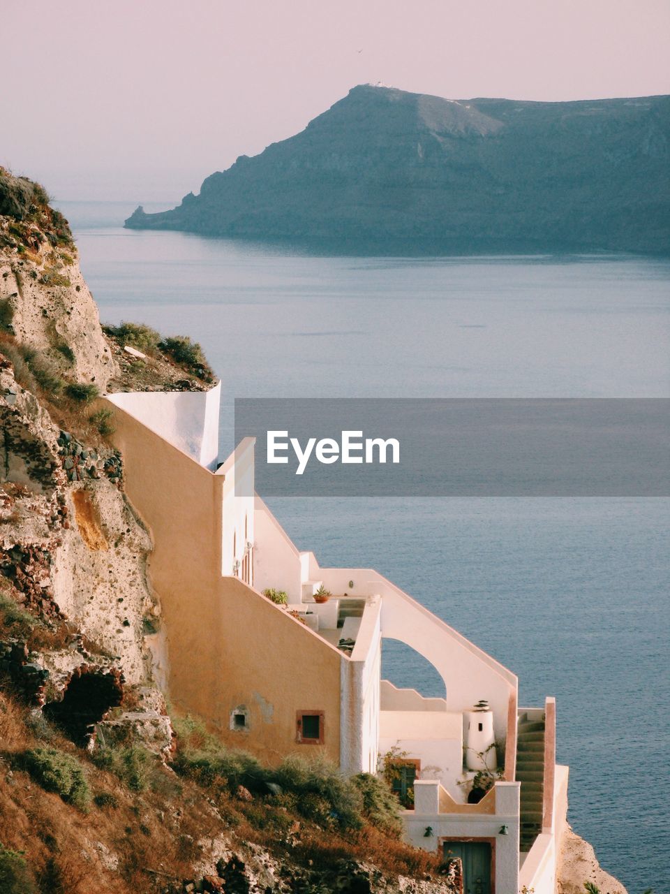 High angle view of sea by mountain against sky