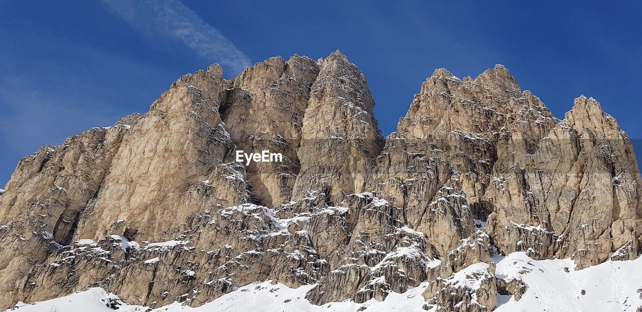 Low angle view of snowcapped mountain against sky